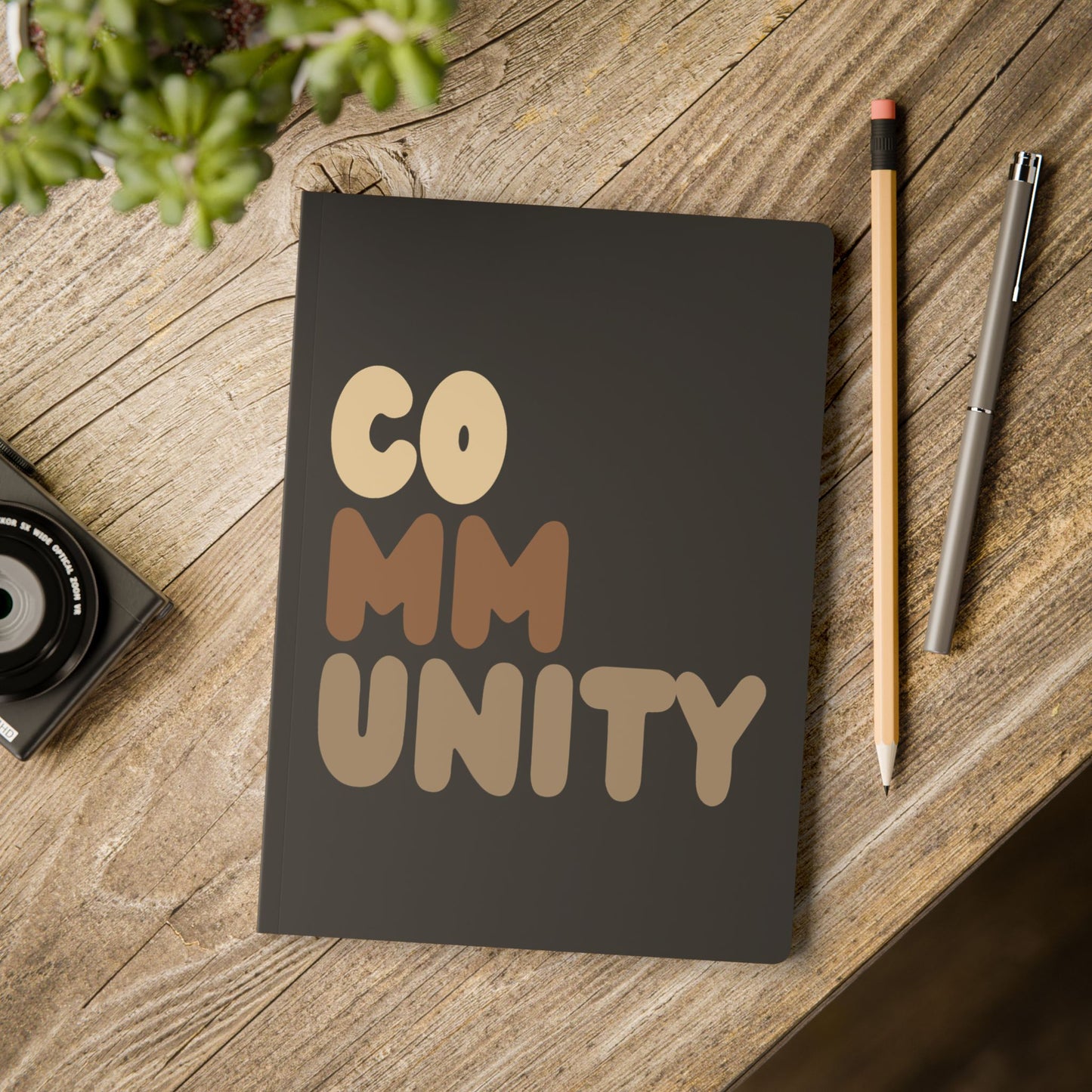 Community Soft Cover Journal on a table - The APWT Gift Shop