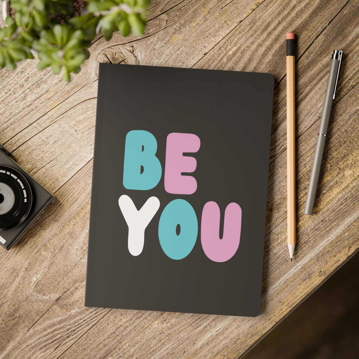 The Be You T Soft Cover Journal on a table - The APWT Gift Shop