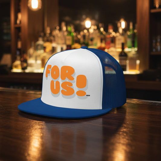 The For Us in Blue and Orange Trucker Hat from the For Us Collection sitting on a wooden bar in a bar