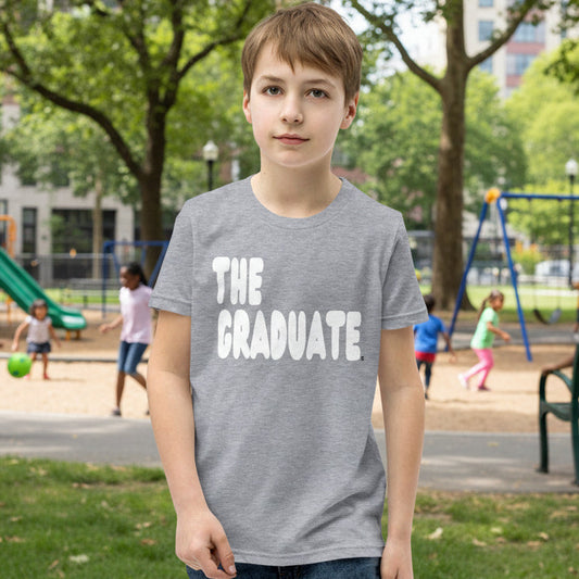 Boy wearing The Graduate Kid's Unisex T-Shirt in Grey from the APWT Gift Shop