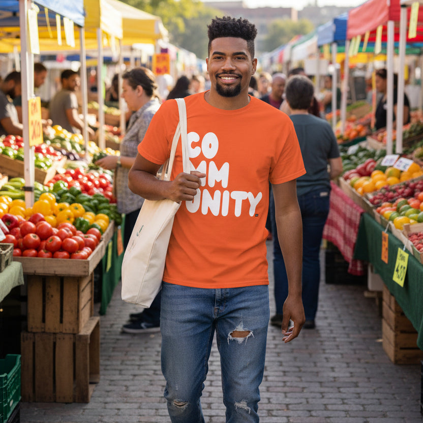 Man wearing A Community in Orange Citrus Unisex T-Shirt from the APWT Gift Shop