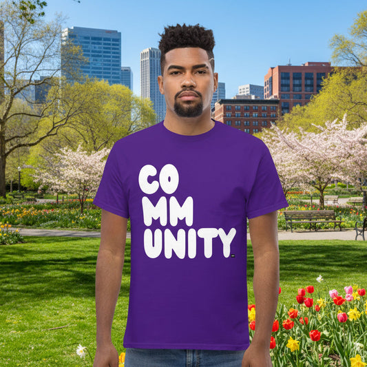Man wearing A Community in Purple Flowers Unisex T-Shirt from the APWT Gift Shop
