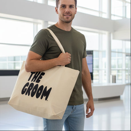 Man wearing The Groom Jumbo Tote Bag from the APWT Gift Shop