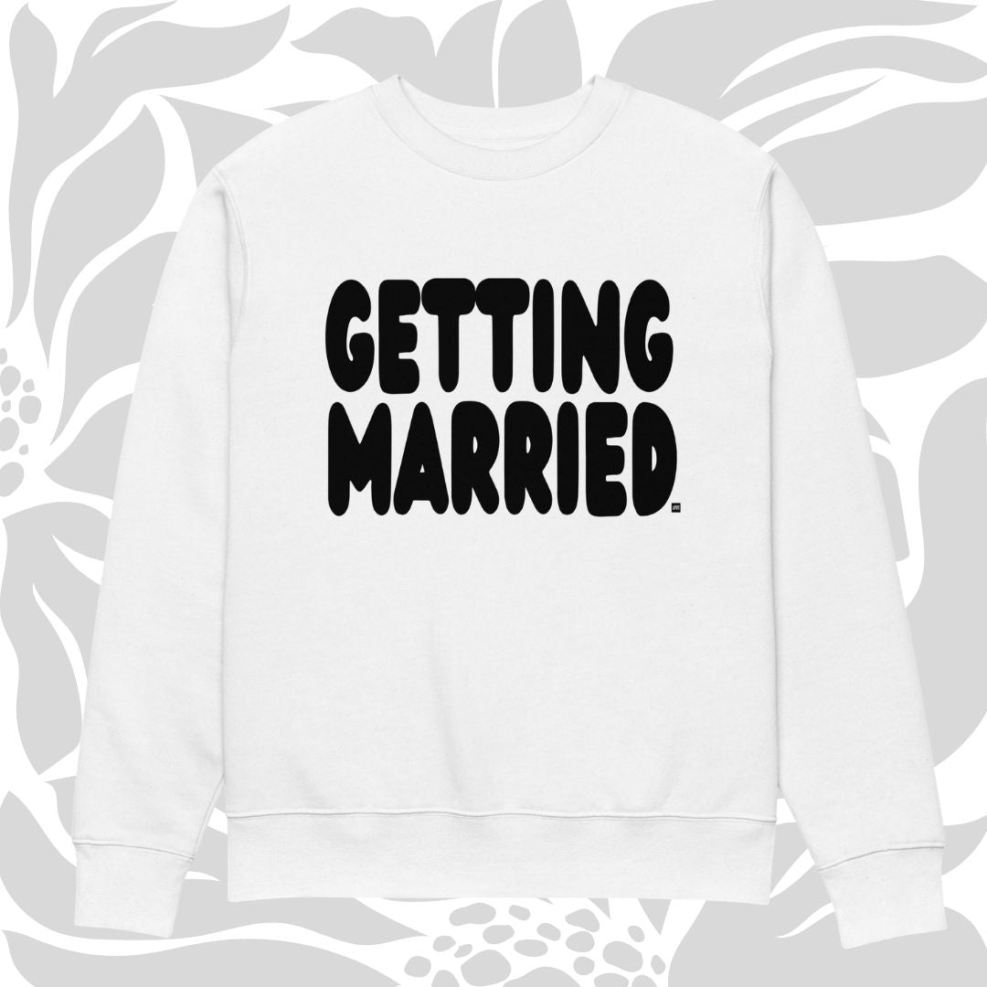 White sweatshirt with 'GETTING MARRIED' text on a floral patterned background