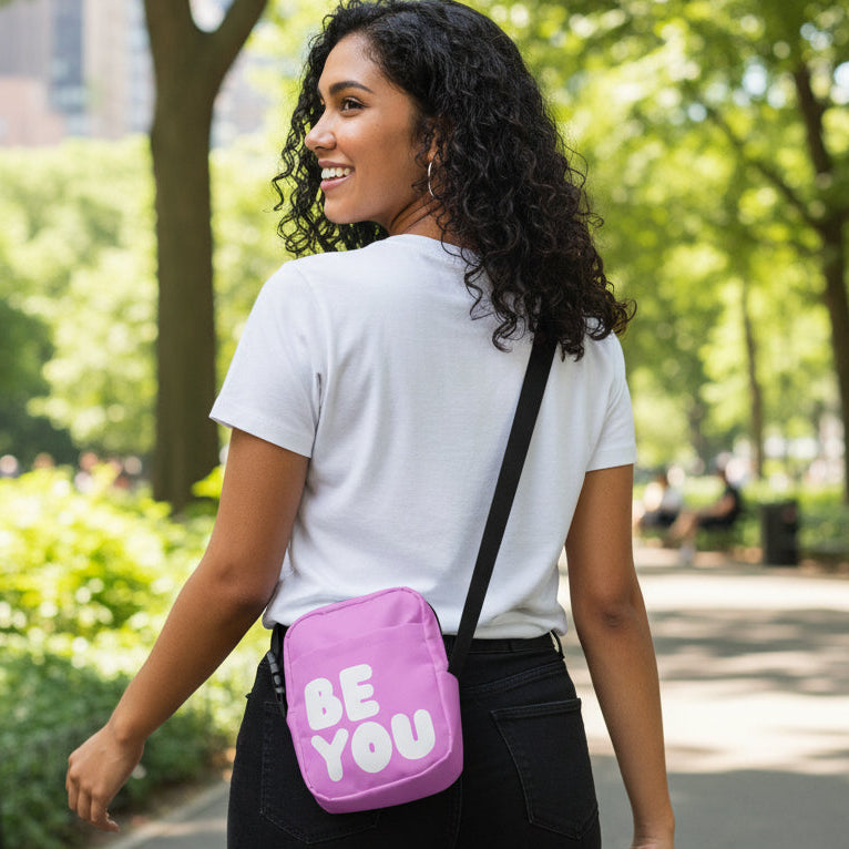 Woman wearing the APWT Gift Shop's Be You in Pink Small Crossbody Bag from the Be You Collection