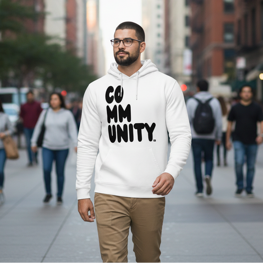 Man walking down a city street wearing A Community in Black and White Premium Unisex White Hoodie from the Community Collection and the Premium Basics Collection