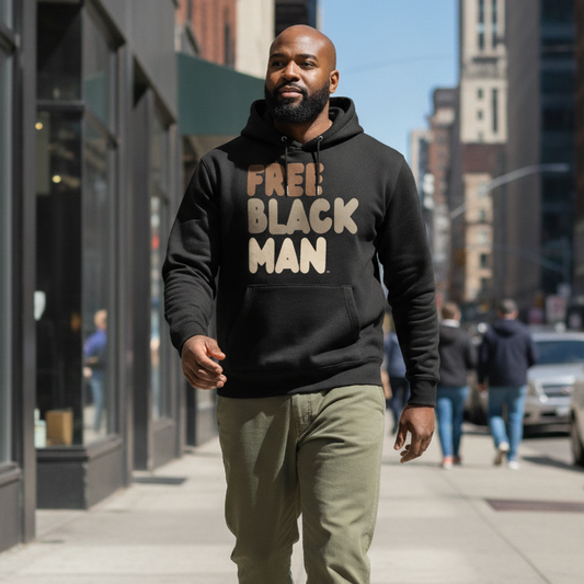 Man walking down a city street wearing the APWT Gift Shop's Free Black Man Premium Unisex Hoodie from the Black Collection and the Premium Basics Collection in Black