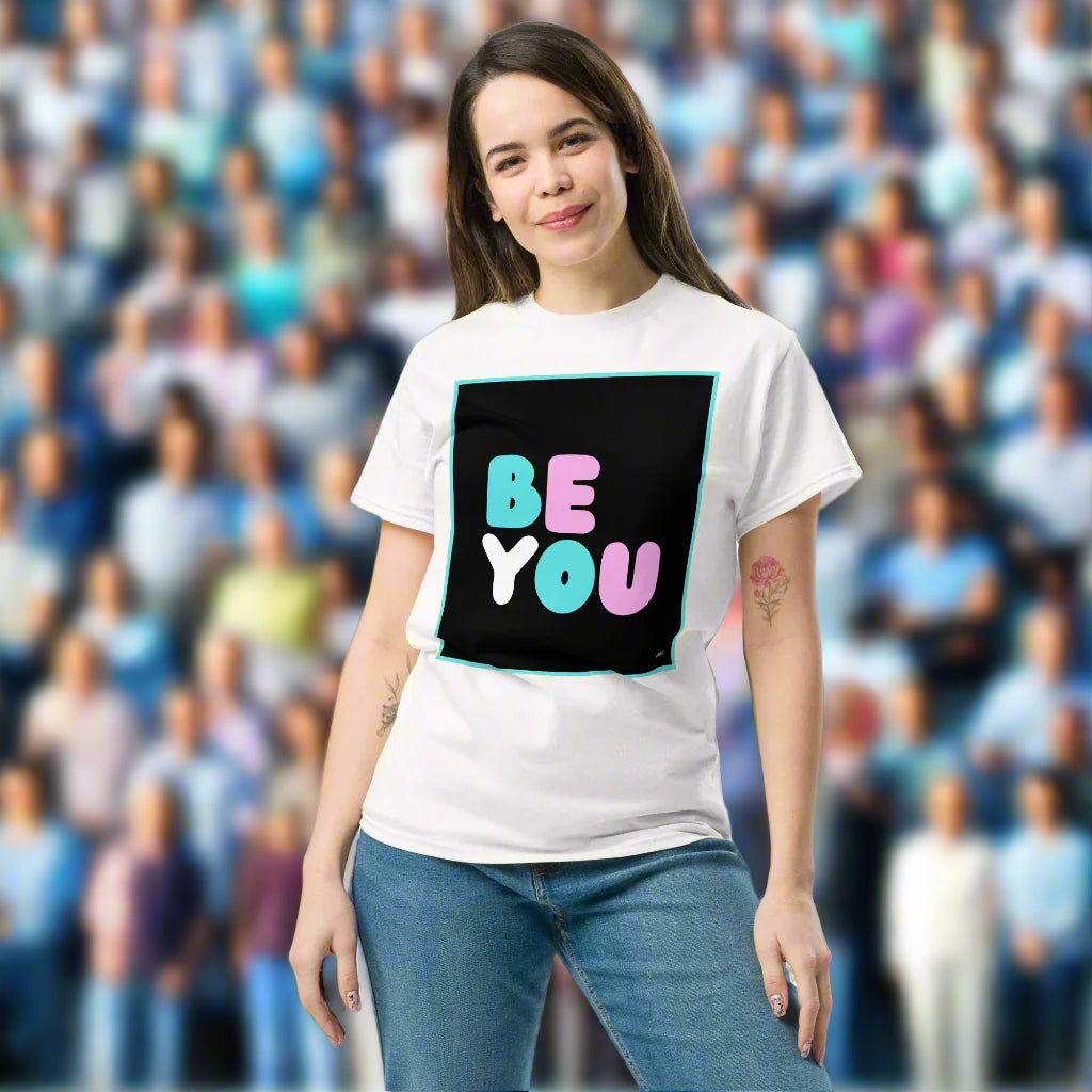 Woman wearing the Be You T Unisex T-Shirt in White standing against a brick wall - The APWT Gift Shop
