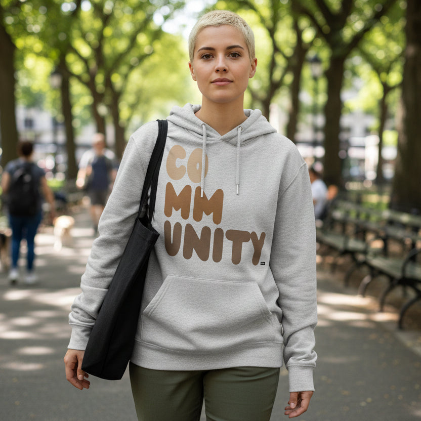 Woman wearing The APWT Gift Shop's Our Community Premium Unisex Hoodie from the Community Collection and the Premium Basics Collection in Grey