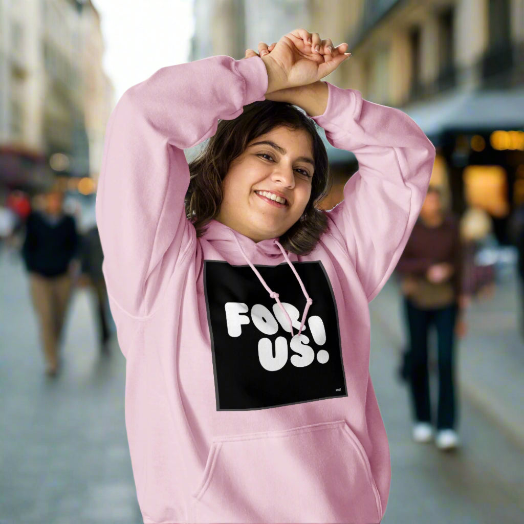 Woman wearing the For Us in Black and White Unisex Hoodie in Pink - The APWT Gift Shop
