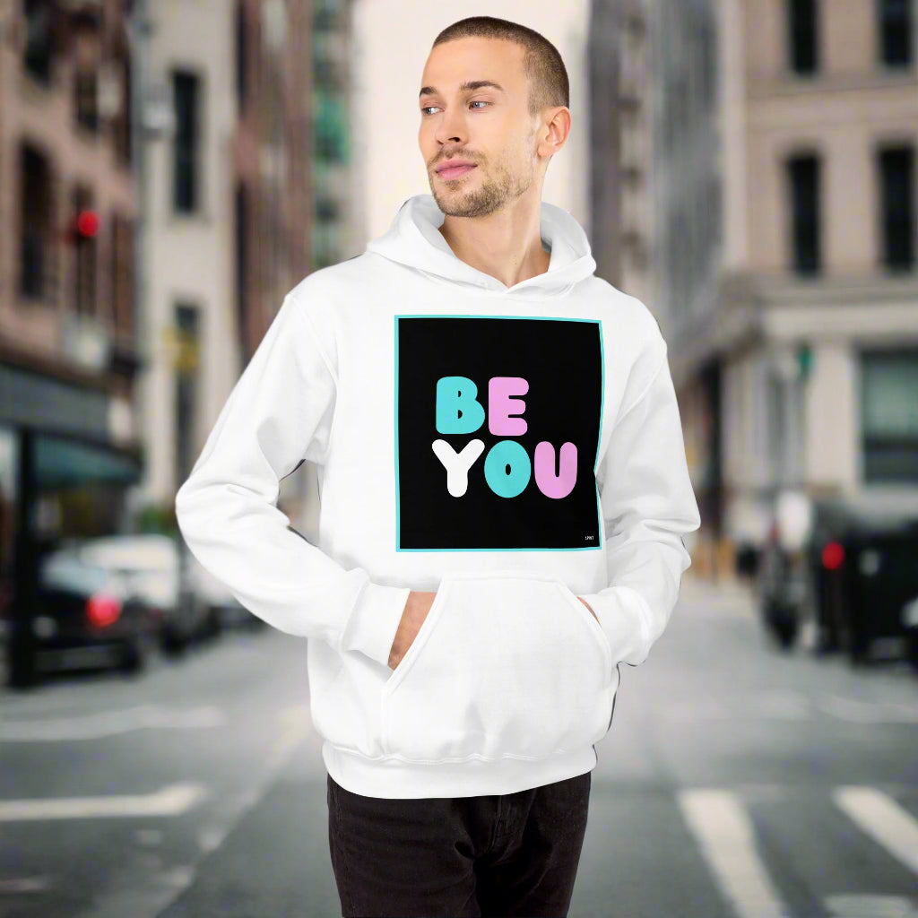 Man wearing the Be You T Unisex Hoodie in White on a city street - The APWT Gift Shop