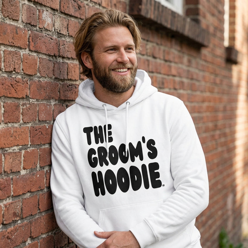 Man wearing the Groom's Hoodie Premium Unisex White Hoodie From the APWT Wedding Shop