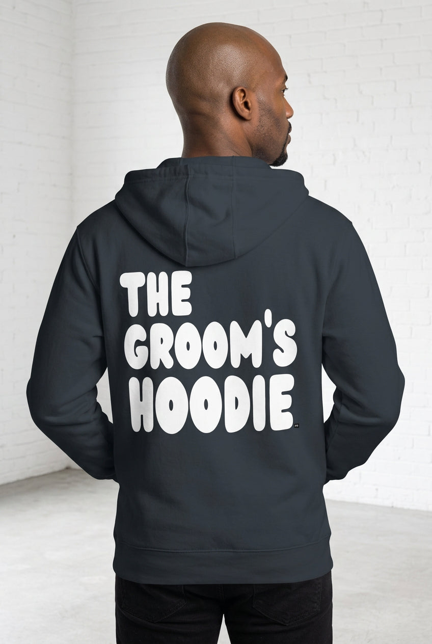 Man wearing the Groom's Hoodie Premium Unisex Zip-Up Hoodie From the APWT Wedding Shop in Navy Blue - Back View