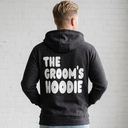 Man wearing the Groom's Hoodie Premium Unisex Zip-Up Hoodie From the APWT Wedding Shop in  Dark Grey - Back View