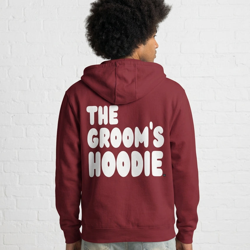 Man wearing the Groom's Hoodie Premium Unisex Zip-Up Hoodie From the APWT Wedding Shop in Burgundy - Back View