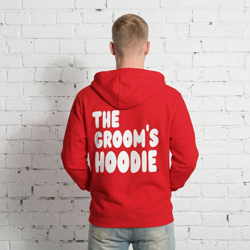 Man wearing the Groom's Hoodie Premium Unisex Zip-Up Hoodie From the APWT Wedding Shop in Red - Back View