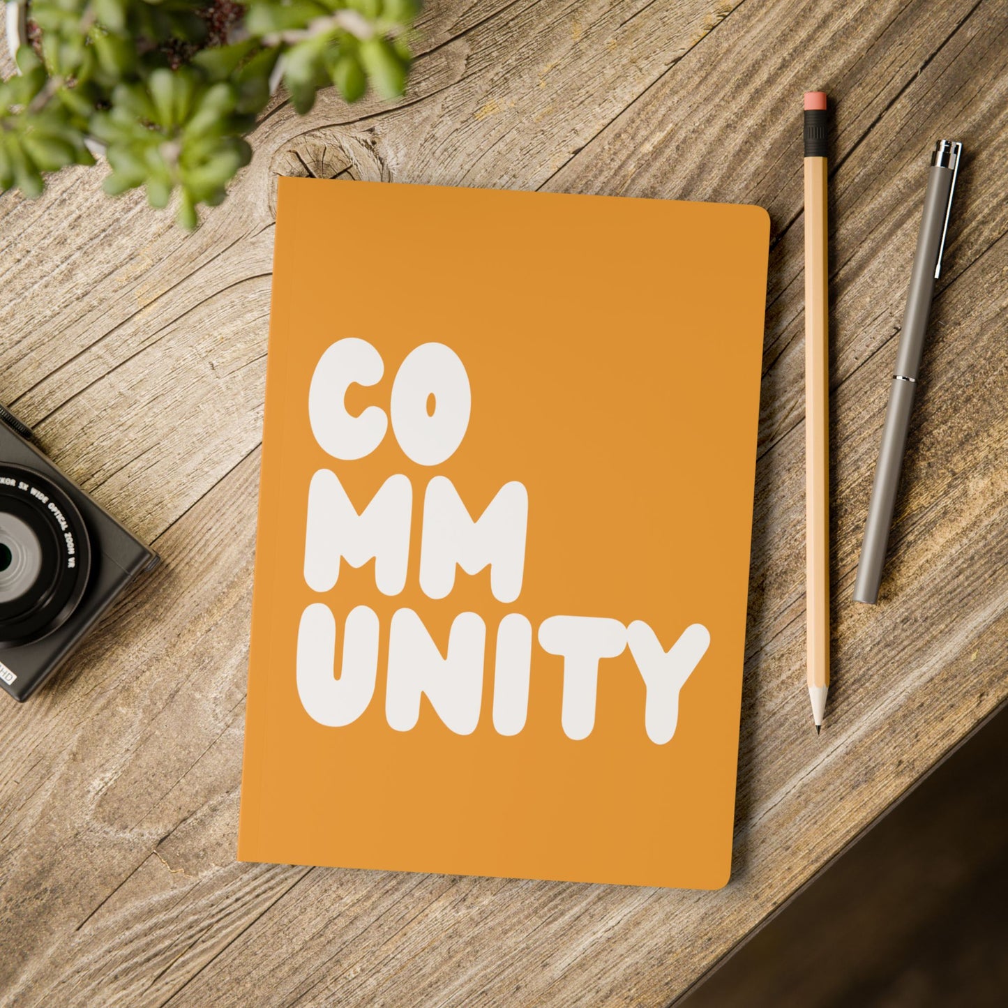 A Community in Orange Soft Cover Journal on a table - The APWT Gift Shop
