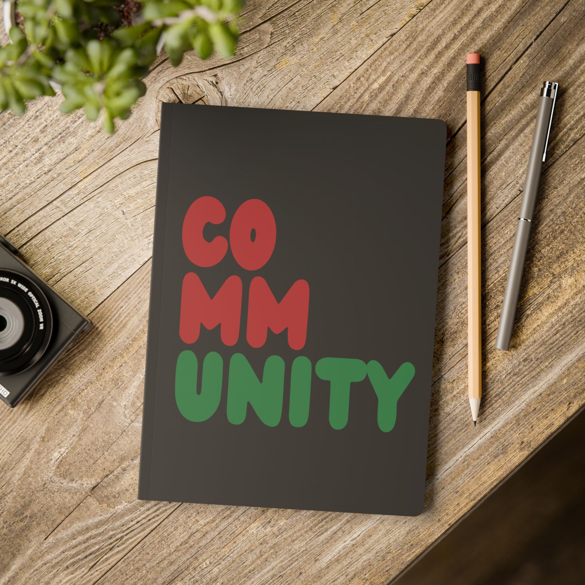 The Black Community Soft Cover Journal on a table- The APWT Gift Shop