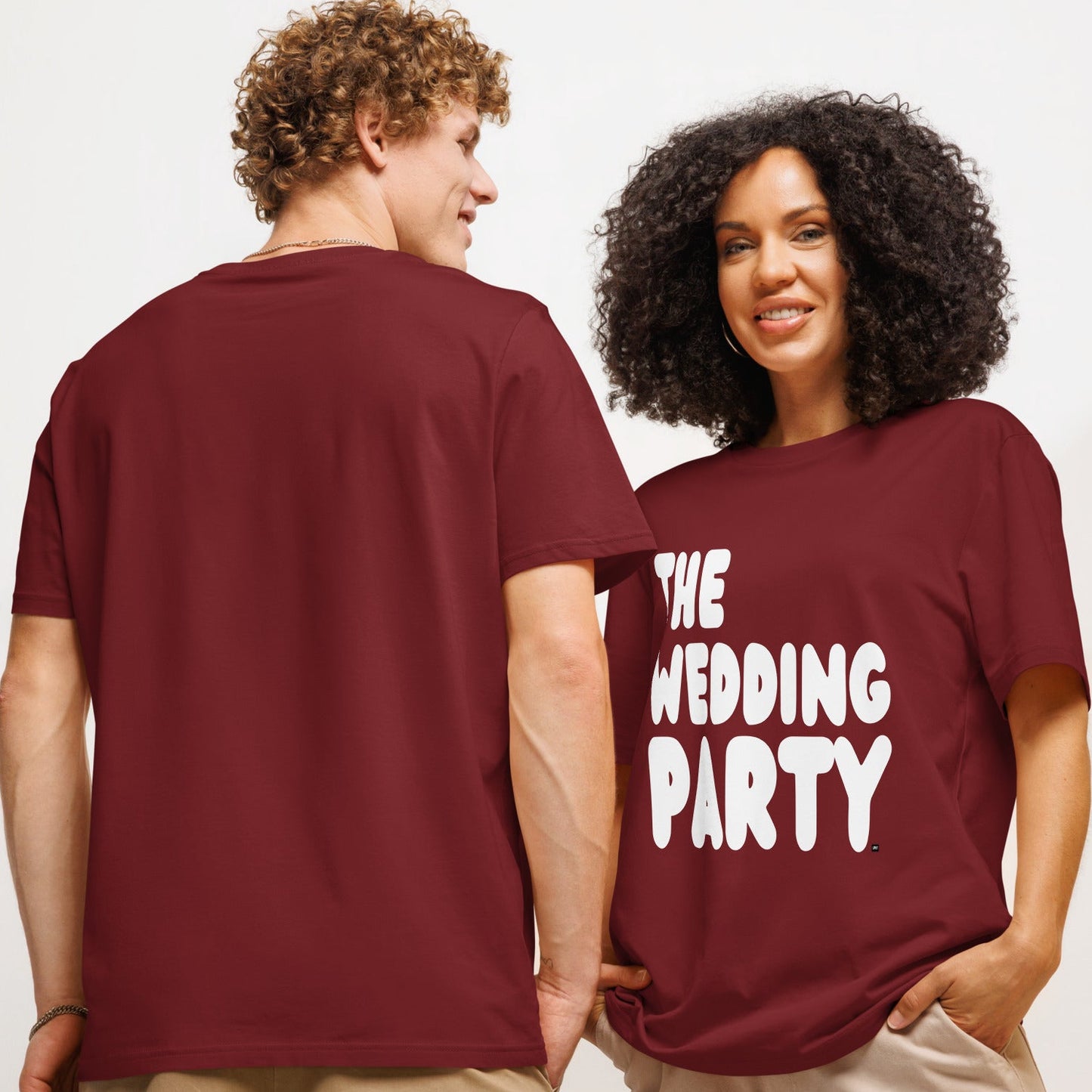 Couple wearing The Wedding Party Premium Unisex T-Shirt in Burgundy from the APWT Gift Shop