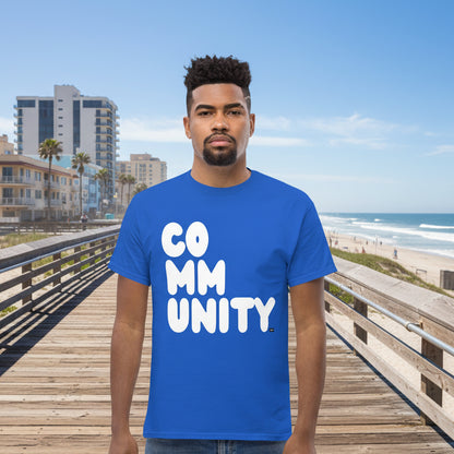Man wearing A Community in Ocean Blue Unisex T-Shirt from the APWT Gift Shop