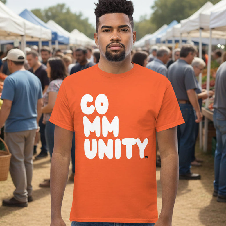 Man wearing A Community in Orange Citrus Unisex T-Shirt from the APWT Gift Shop