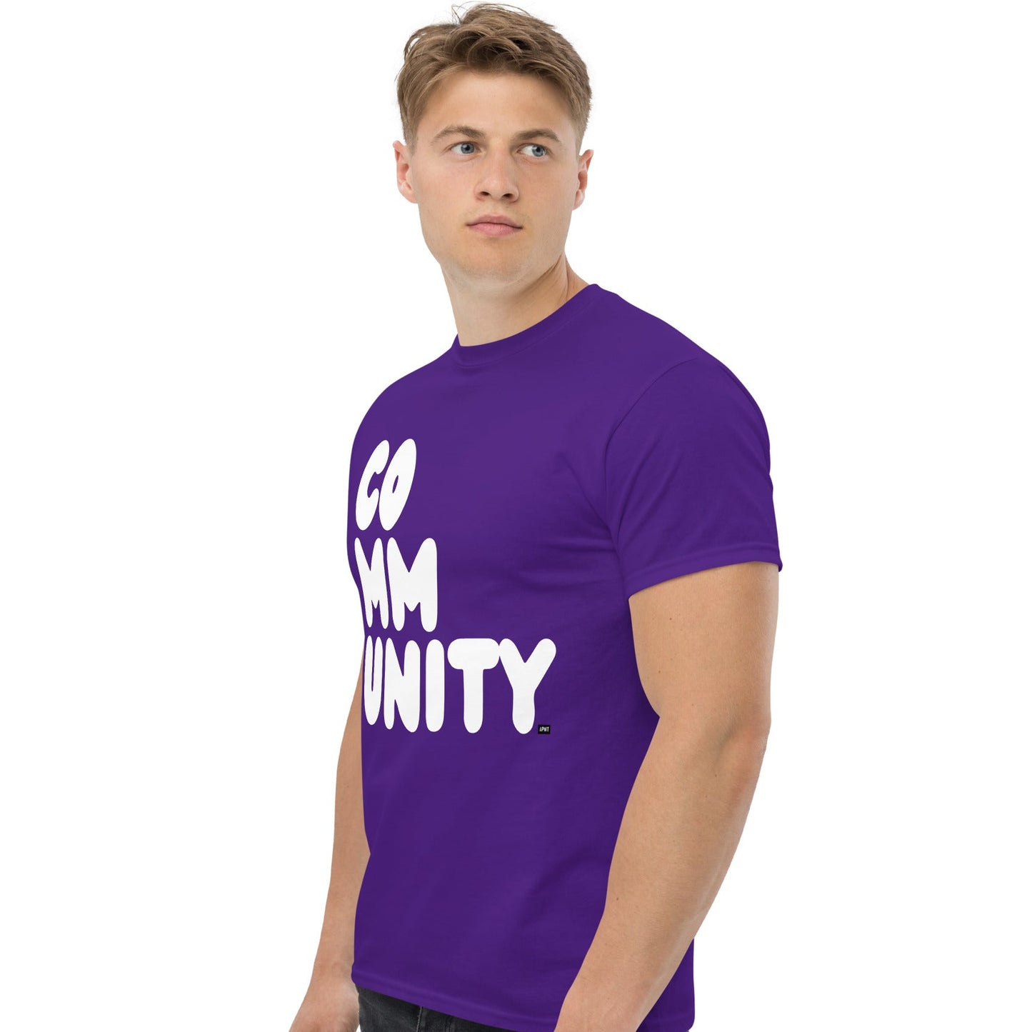 Man wearing A Community in Purple Flowers Unisex T-Shirt from the APWT Gift Shop Side