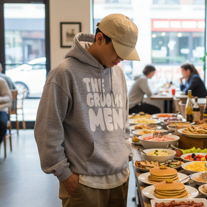 Man wearing The Groomsmen Unisex Hoodie in Grey