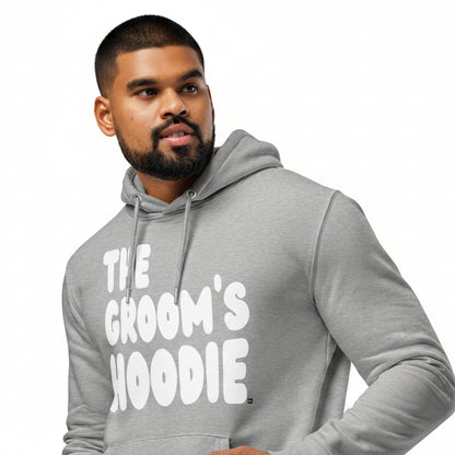 Man wearing the APWT Gift Shop's The Groom's Hoodie Premium Unisex Hoodie from the APWT Wedding Shop in Grey