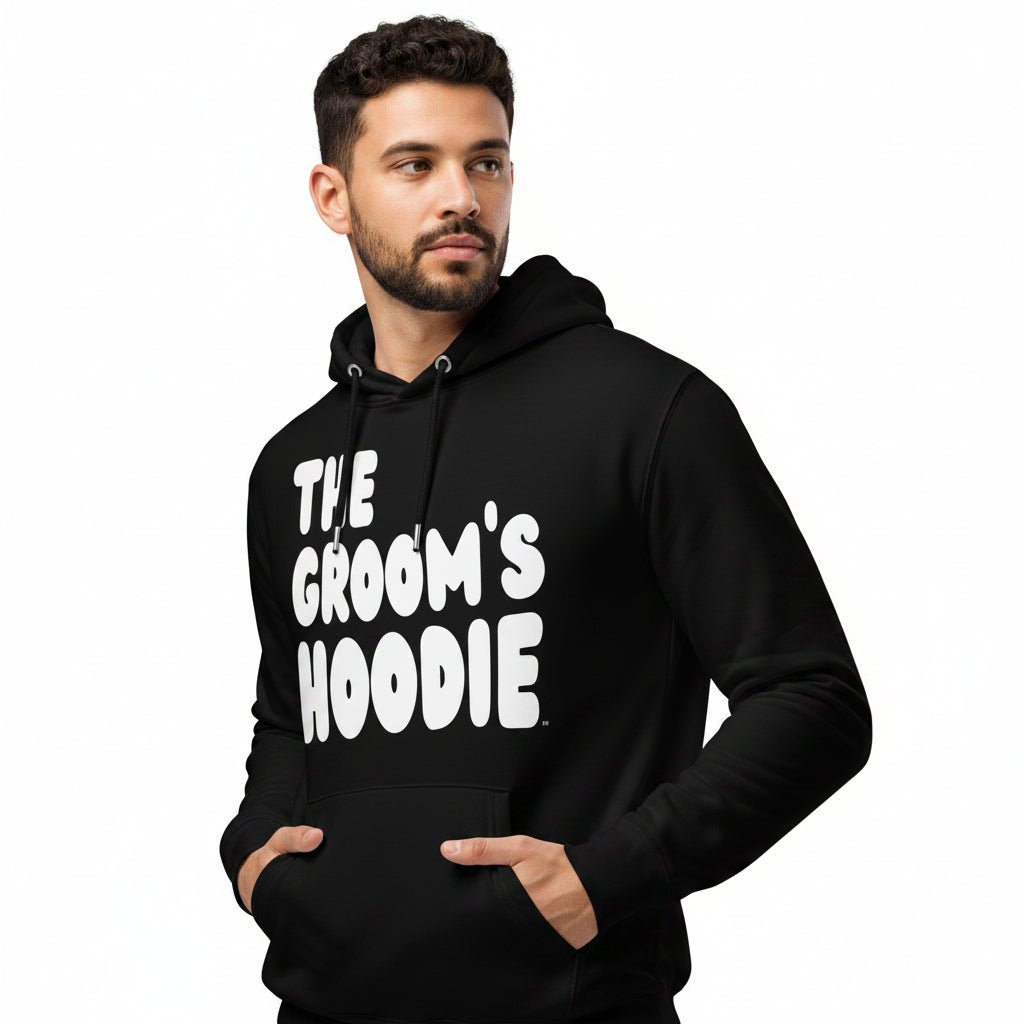 Man wearing the The Groom's Hoodie Premium Unisex Hoodie in black from the APWT Gift Shop