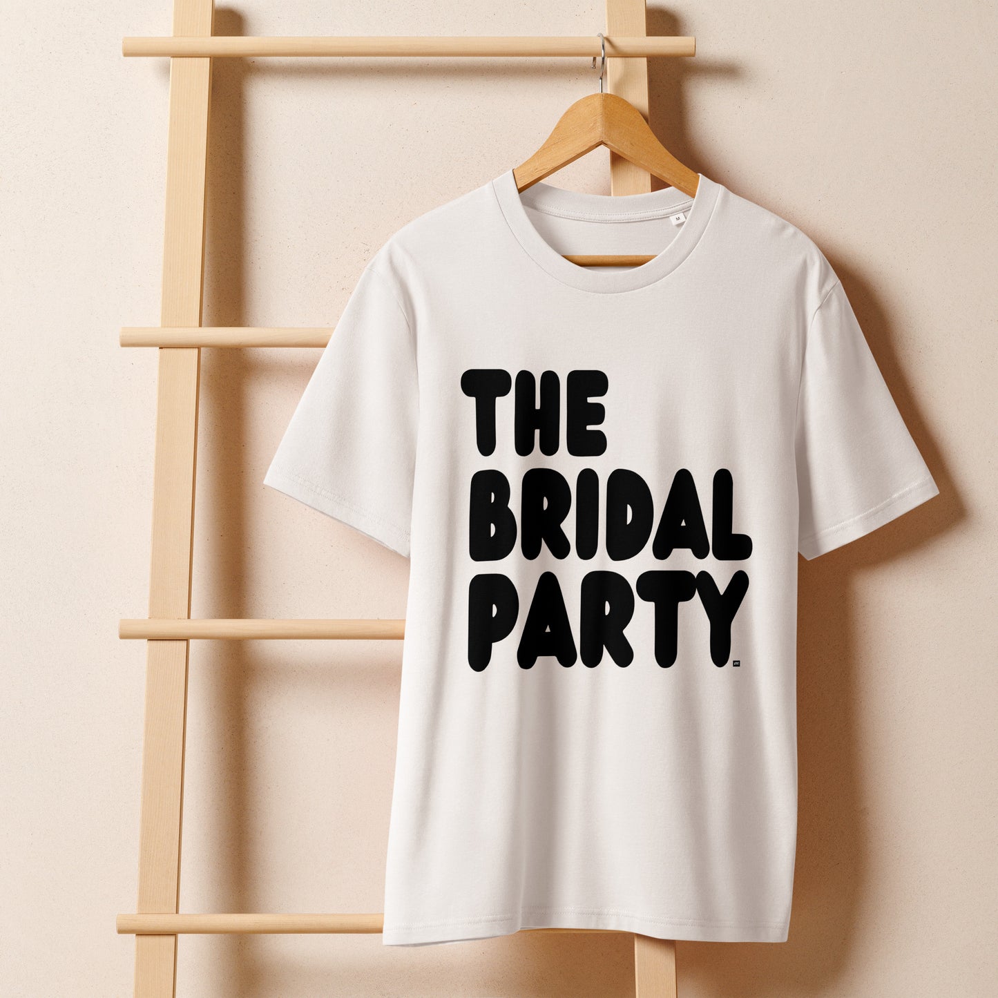 The Bridal Party Premium Unisex White T-Shirt on a hanger - The APWT Gift Shop