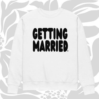 White sweatshirt with 'GETTING MARRIED' text on a floral patterned background
