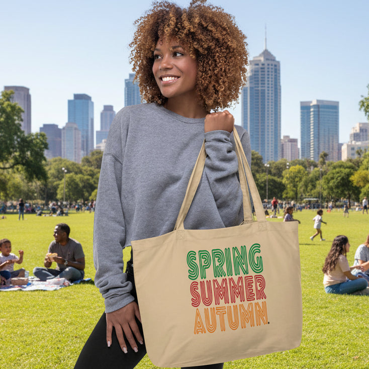 Woman holding The Spring into Summer Jumbo Tote Bag from the APWT Gift Shop in Natural