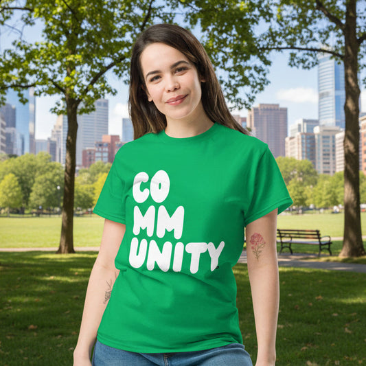 Woman wearing A Community in Green Grass Unisex T-Shirt from the APWT Gift Shop