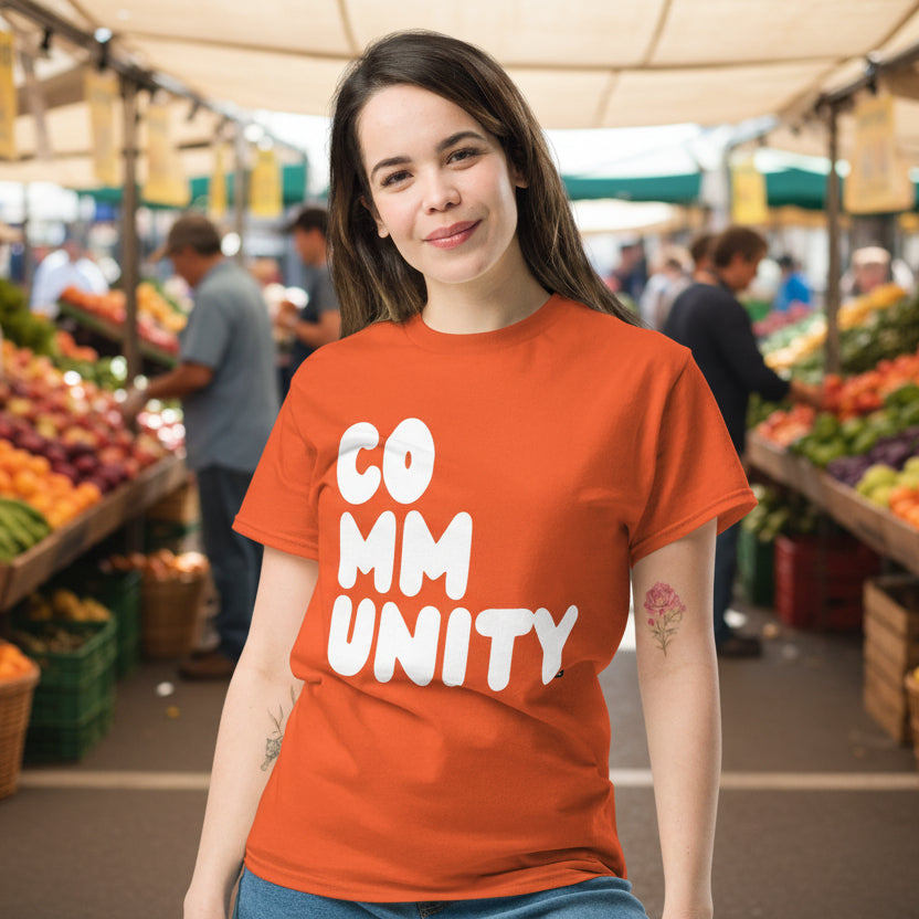 Woman wearing A Community in Orange Citrus Unisex T-Shirt from the APWT Gift Shop
