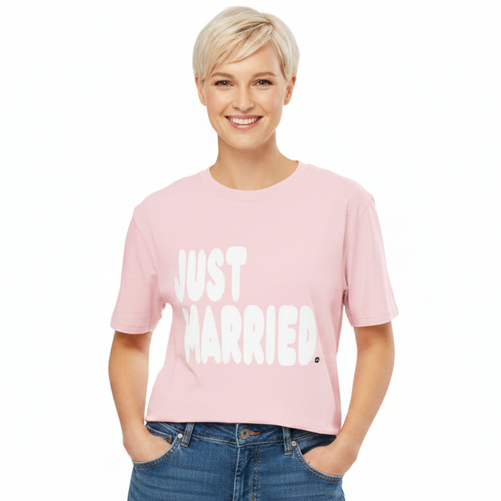 Woman wearing the APWT Gift Shop's Just Married Premium Unisex T-Shirt in Pink from the APWT Wedding Shop