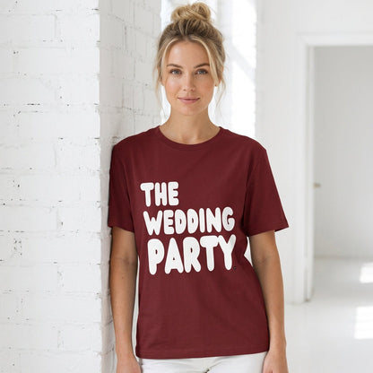 Woman wearing The Wedding Party Premium Unisex T-Shirt in Burgundy from the APWT Gift Shop