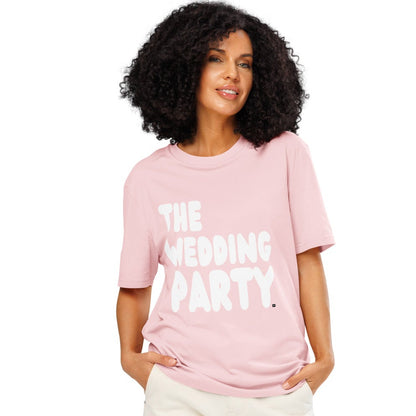 Woman wearing The Wedding Party Premium Unisex T-Shirt in Pink from the APWT Gift Shop