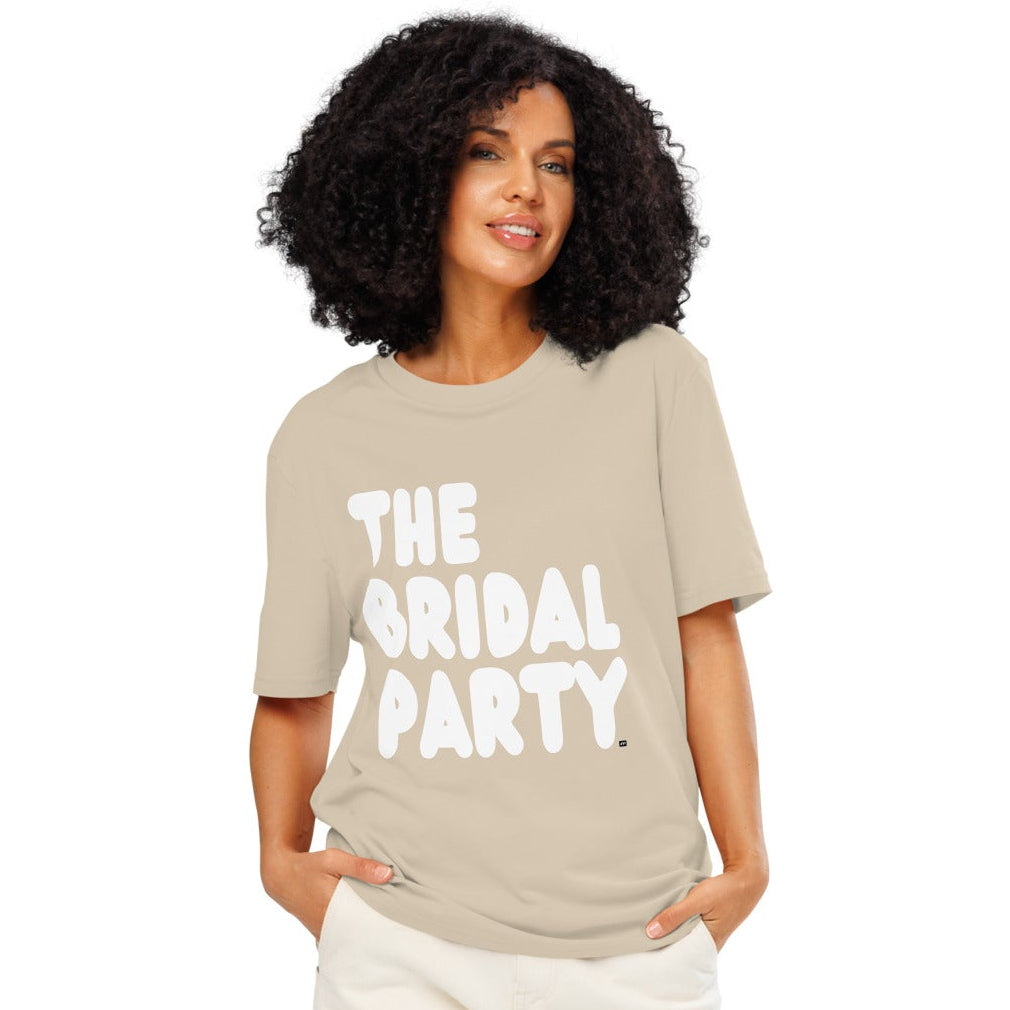 Woman wearing the APWT Gift Shop's the Bridal Party Premium Unisex T-Shirt in Beige from the APWT Wedding Shop