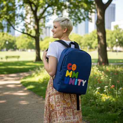 Woman walking through the park wearing the APWT Gift Shop's Rainbow Community Backpack from the Pride in the APWT Gift Shop Collection