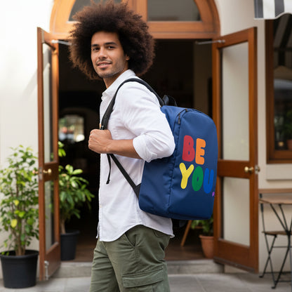 Man wearing the APWT Gift Shop's Rainbow Be You Backpack from the Pride in the APWT Gift Shop Collection