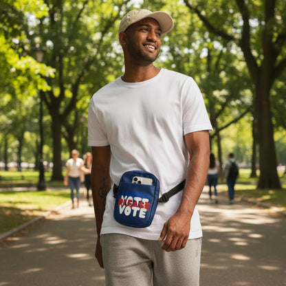 Man walking in the park wearing The APWT Gift Shop's Please Vote Small Crossbody Bag from the APWT Vote Shop