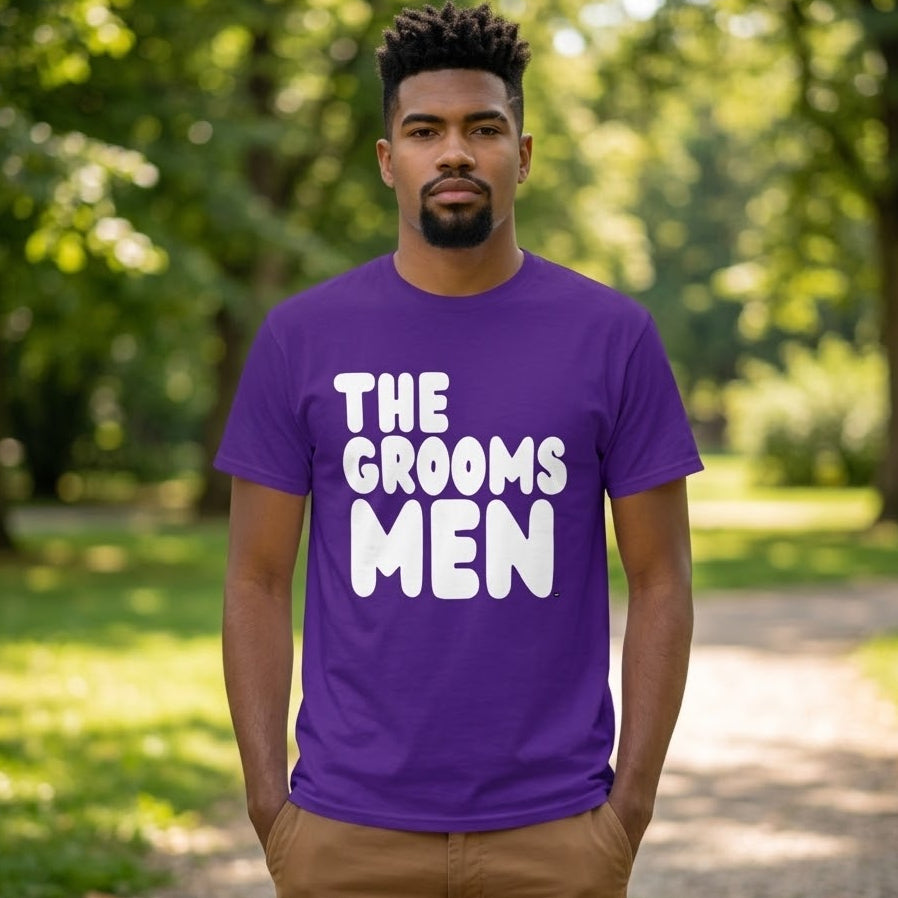 Man standing in a park wearing the APWT Gift Shop's the Groomsmen Unisex T-Shirt  from the APWT Wedding Shop and Day in the Life Collection in Purple