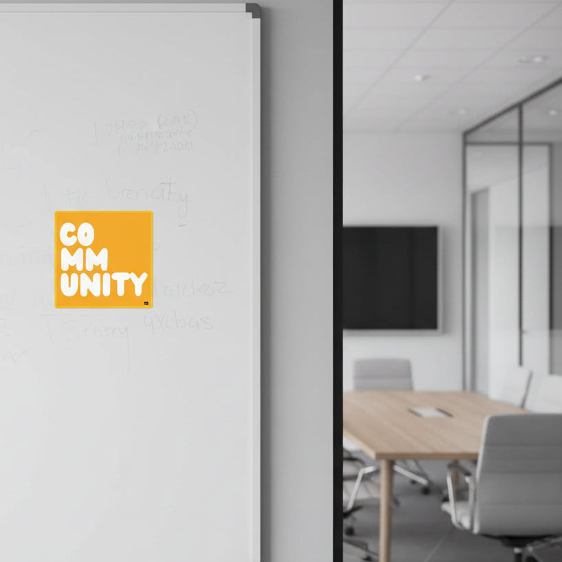 A Community in Sunflower Yellow Vinyl Sticker stuck to a white board outside of a conference room