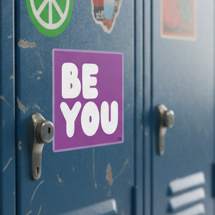 The APWT Gift Shop's Be You in Purple Sticker from the Be You Collection stuck to a school locker