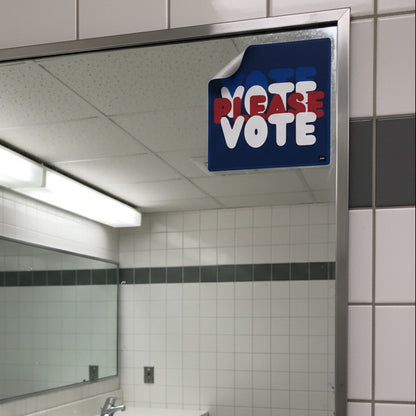 The APWT Gift Shop's Please Vote Vinyl Sticker from the APWT Vote Shop stuck to the mirror in a public bathroom