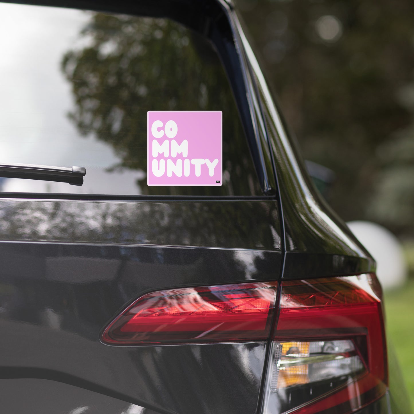 A Community in Pink Vinyl Sticker on a car window - The APWT Gift Shop