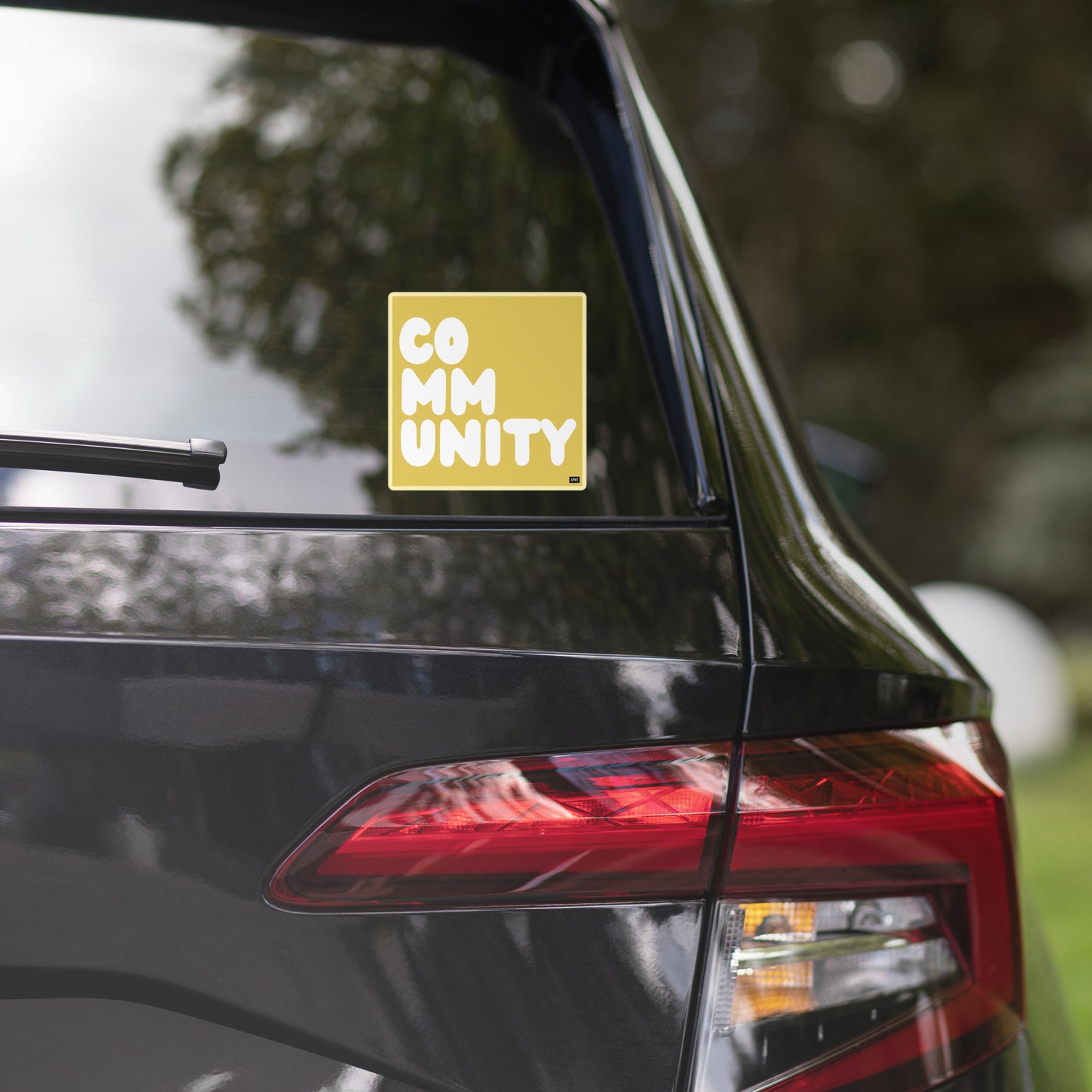 A Community in Yellow Vinyl Sticker on a back car window - The APWT Gift Shop