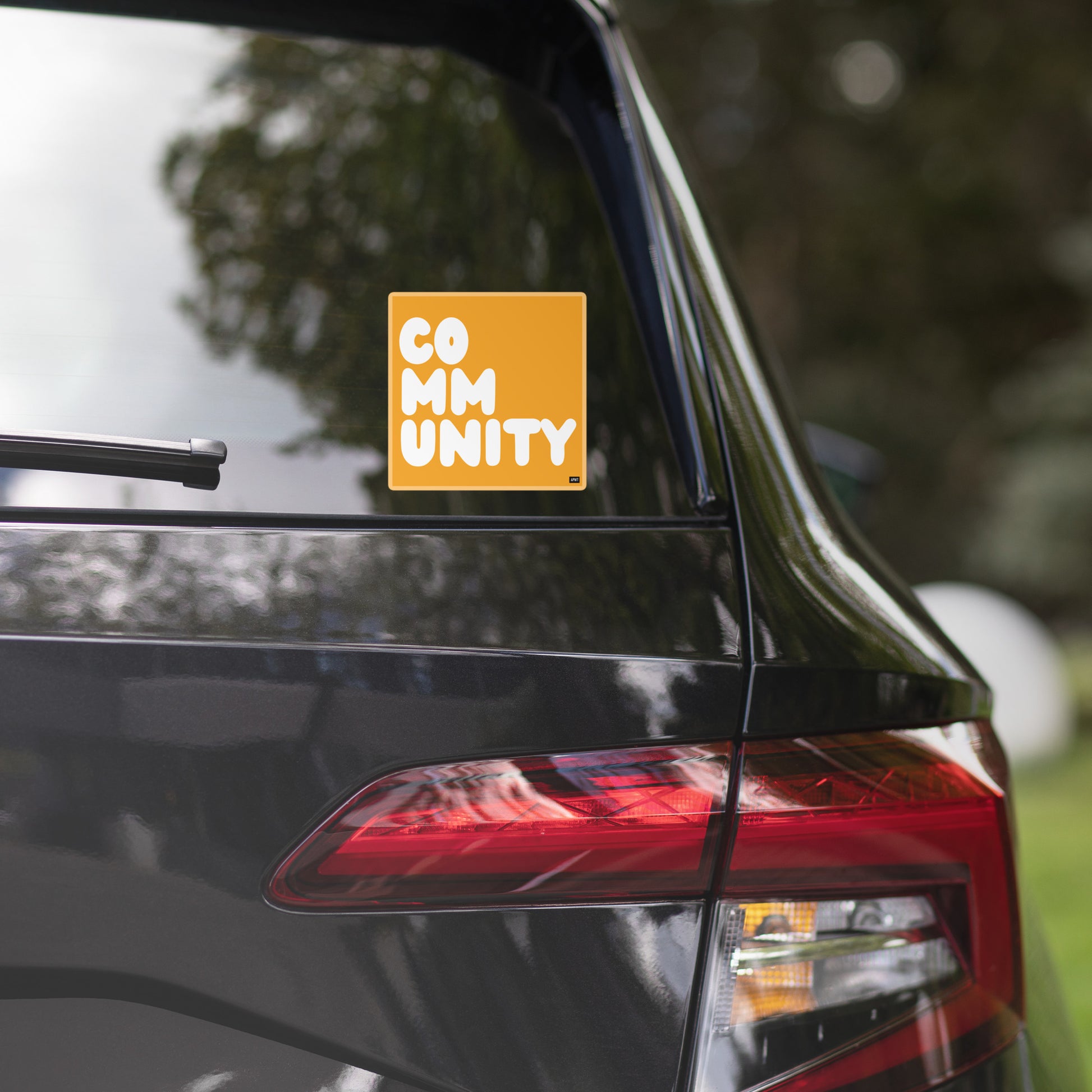 A Community in Orange Vinyl Sticker on a car window - The APWT Gift Shop