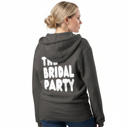 Woman wearing the APWT Gift Shop's the Bridal Party Premium Unisex Zip-Up Hoodie from the APWT Wedding Shop in Charcoal Grey