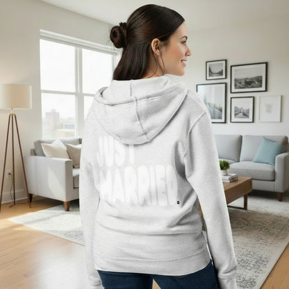 Woman standing in a living room wearing the APWT Gift Shop's Just Married Premium Unisex Zip-Up Hoodie in Grey from the APWT Wedding Shop
